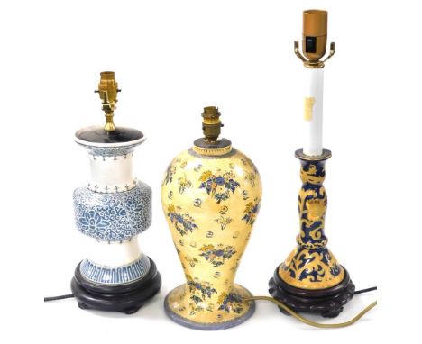 A Chinese porcelain candlestick table lamp, gilt decorated with scrolling flowers against a blue ground, 52cm high, a papier 