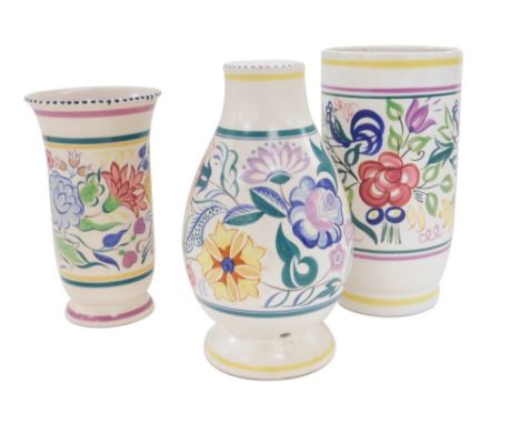 Three Poole pottery vases, each decorated with a central band decorated with flowers with further coloured banded decoration,