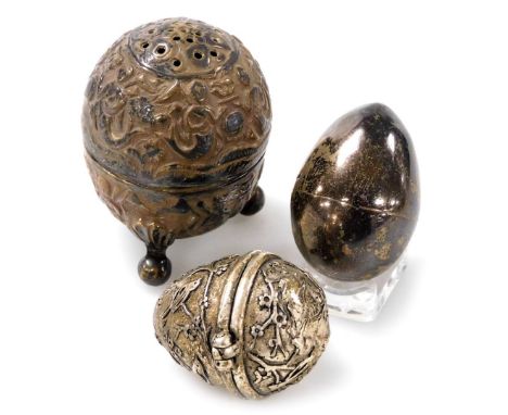 A Georgian silver thimble holder, of egg form, hallmarks indistinct, together with an Indian white metal pepperette embossed 