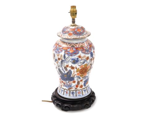 A Chinese porcelain jar and cover table lamp, of baluster form, Imari decorated with flowers and scrolling leaves, raised on 