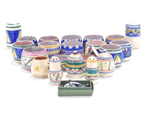 A group of Poole pottery, comprising twelve egg cups, pair of miniature salt and pepper shakers, pair of open salts, pair of 