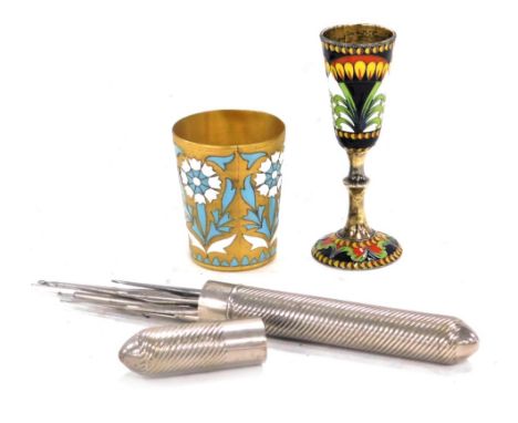 An early 20thC Russian gilt metal tot, with enamelled decoration in white and turquoise of repeating flowers, impress mark, 5