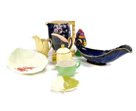 A group of Carltonware pottery, including a powder blue ground jug enamel decorated with flowers and blossom, leaf shaped dis