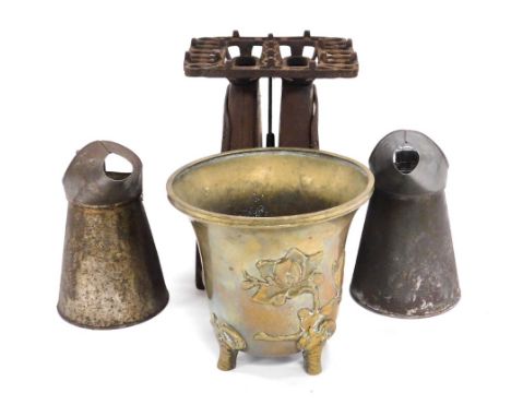 A Qing Dynasty bronze urn, embossed with magnolias, 18cm high (AF), together with a cast iron stove, and two one litre oil ca