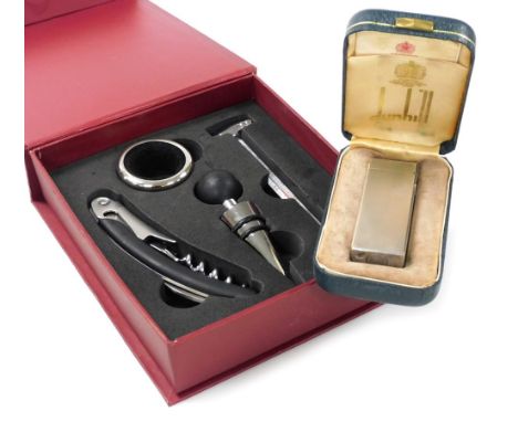 A Dunhill silver plated pocket lighter, with engine turned decoration, boxed, together with a bar set. (2)