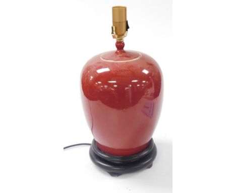 A Chinese Sang-de-boeuf table lamp, raised on a socle base, 48cm high.&nbsp;Buyer Note: WARNING! This lot contains untested o