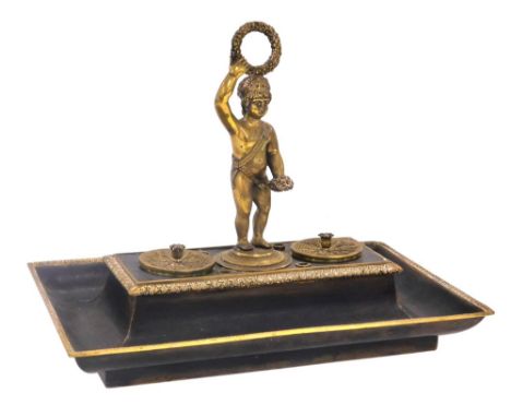 A late 19thC French bronze and brass encrier, of rectangular form, with a central carrying figure of a putto, flanked by a br