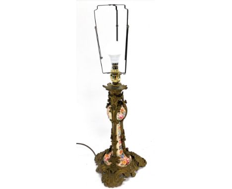 A late 19thC pottery and brass overlaid candlestick, converted to a table lamp, painted with flowers, with floral and foliate