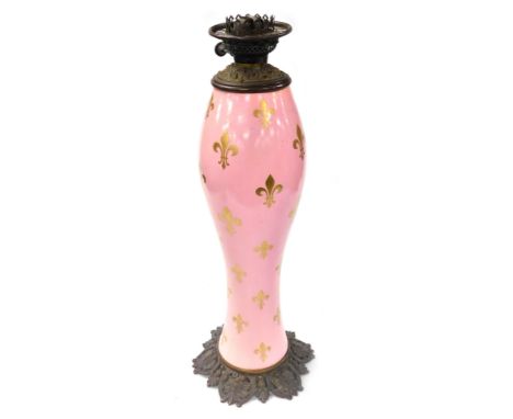 A late 19thC French ceramic and brass table lamp, of baluster form, the body decorated with fleur-de-lis against a pink groun