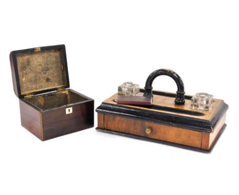 A Victorian walnut and ebonised desk stand, with two glass inkwells, covers lacking, pen recesses, and a frieze drawer, 28cm 