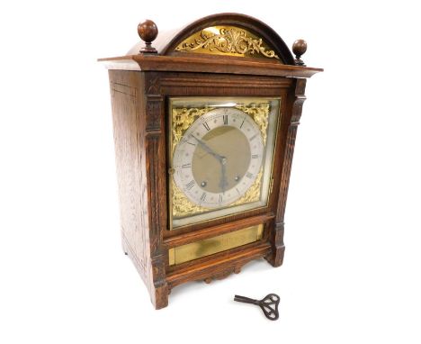 A Victorian oak cased mantel clock, by Martin Wilkinson of Newark, square brass dial, with gilt foliate spandrels, silvered c