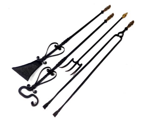 A set of three Victorian brass and cast iron fire implements, with figural monopodia handles, comprising a shovel, pair of to