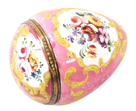 A late 18thC Bilston enamel egg, possibly originally a nutmeg grater, painted with reserves of flowers, against a pink enamel