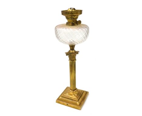 An early 20thC brass Corinthian column oil lamp, with a clear honeycomb glass reservoir, no chimney or shade, 55cm high. 