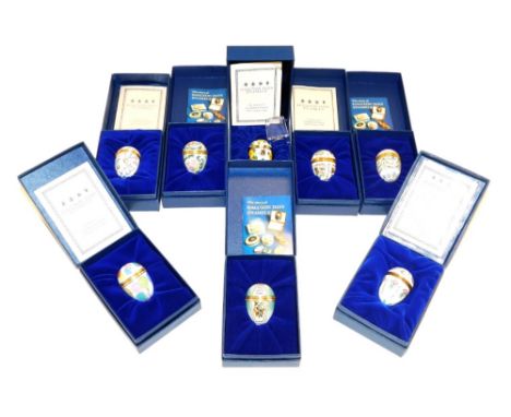 Eight Halcyon Days enamel egg shaped trinket boxes, of varying designs, to include flowers, woodland animals, balloons, etc.,