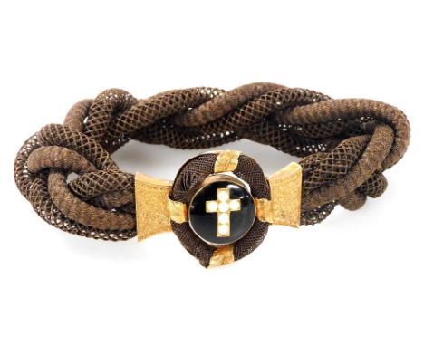 A Victorian mourning bracelet, with a central seed pearl cross on a black enamel ground, with gilt metal mounts, on a woven h