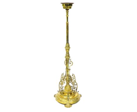A Victorian brass standard oil lamp base, with a fluted column and scrolling arms, raised on a circular base and three foliat