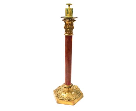 A late 19thC Continental brass and wooden candle lamp, with embossed decoration, raised on a hexagonal base, 58cm high.&nbsp;