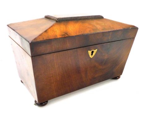 A Regency mahogany sarcophagus form tea caddy, the hinged lid opening to reveal two lidded compartments, with brass escutcheo