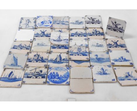 A group of 18thC and later Delftware blue and white tiles, decorated with windmills, houses, figures, birds, and animals. (a 