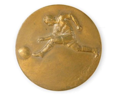 A World War Two bronze football medallion, obverse embossed with a footballer kicking a ball, reverse B.B.C.9.L of C. Champio