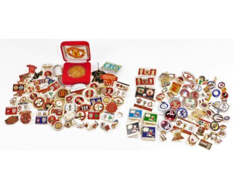 A group of Manchester United enamel badges, together with a commemorative medallion for The Treble 1998-1999, boxed. 