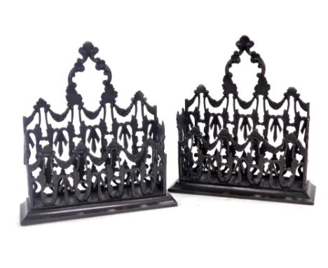 A pair of bronze wall pockets, open cast with scrolling leaves and floral garlands, 17.5cm wide.