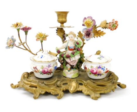 A 19thC Continental porcelain and brass desk stand, the stand surmounted by a figure of a girl holding vines, flanked by two 