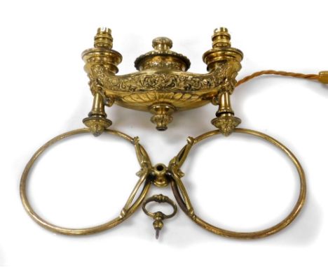 A Victorian brass hanging twin branch gasolier, converted to electricity, of Roman oil lamp form, embossed with flowers and s