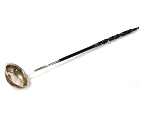 A George III silver toddy ladle, the bowl of oval form with a twisted whale bone handle, Stephen Adams II, London 1807, 31cm 