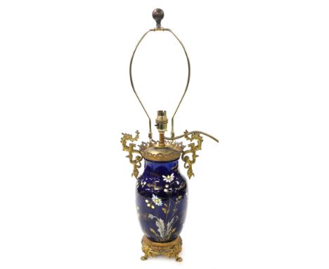 A late 19thC French ceramic and brass mounted vase, enamel decorated with flowers, gilt heightened, with later lamp fitting, 