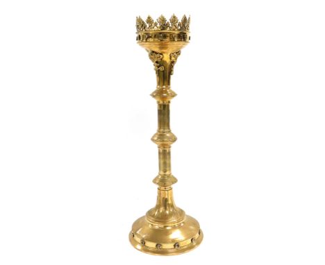 A Victorian brass Gothic Revival pricket altar candlestick, embossed with flower heads and engraved with leaves, 51cm high. 