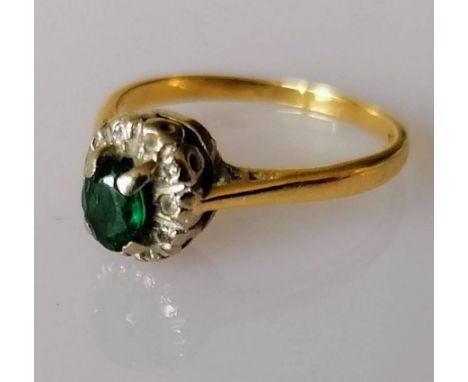 An emerald and diamond cluster ring on 18ct white and yellow gold, stamped, size K, 2.52g