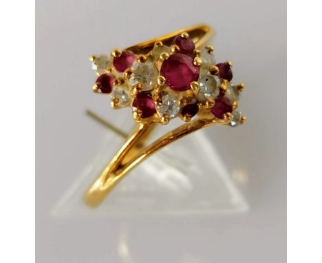 A ruby and diamond cluster ring on an 18ct gold setting, size P, stamped, 3.61g