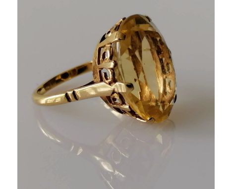 An oval faceted citrine dress ring on a gold basket setting, 20mm x 15mm, stamped 9ct, size P, 6.57g