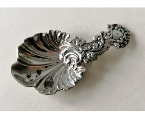 A Victorian silver caddy spoon with elaborate rococo decoration, scallop bowl by Martin, Hall &amp; Co., Sheffield, 1856, 9 x