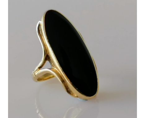 An elliptical onyx dress ring on a yellow gold setting, size M, stamped 9ct, 8.62g