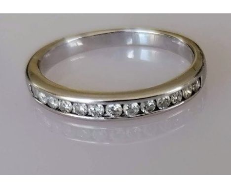 A diamond half-hoop eternity ring, the 18ct white gold band set with thirteen round brilliant-cut diamonds in a channel mount