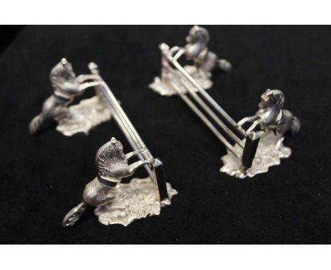 Pair of White Metal Knife Rests in form of Gate and Leaping Horses