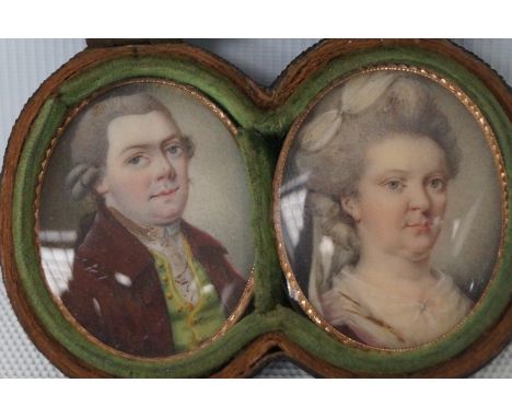 Pair of portrait miniatures of a gentleman wearing a red jacket and wig, the lady wearing a ribbon in her hair, initialled an