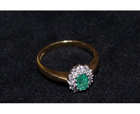 18 carat gold ring set with diamonds and central emerald, size P, 4.4 grams  