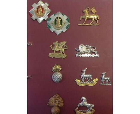 A large collection of over 160 British Army and Commonwealth cap badges, WW1 and later plus some Regimental buttons. Containe