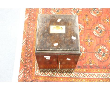 A wooden coin cabinet with a selection of various coins. 