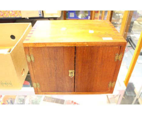 A Coin Cabinet in Mahogany with Plywood Shelves.