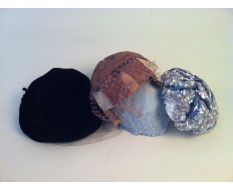 A COLLECTION OF 1950'S HATS. To include one soft silk black velvet hat, lined in tulle with lace hair net labelled 'Model Mil