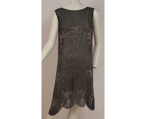 A 1920'S BEADED FLAPPER DRESS Entirely embroidered in silver bugle beads, glass beads and beads of silver, on a fine black co