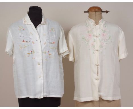 TWO VINTAGE EMBROIDERED BLOUSES A pretty cream silk blouse with embroidered flowers and toggle buttons, mandarin collar. Labe
