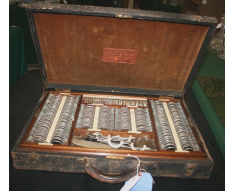 OPTOMETRIST CASED SET OF LENSES - QUEENS UNIVERSITY BELFAST a leather cased set with two layers of various lenses for an Opti