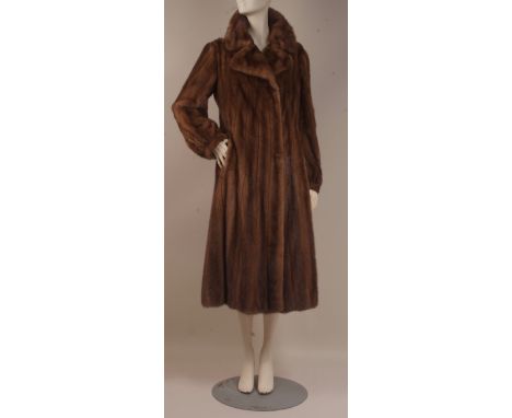A VINTAGE RANCHED WILD MINK FUR COAT An elegant light brown full length, swing back coat with a beautiful mink lustre. The pe
