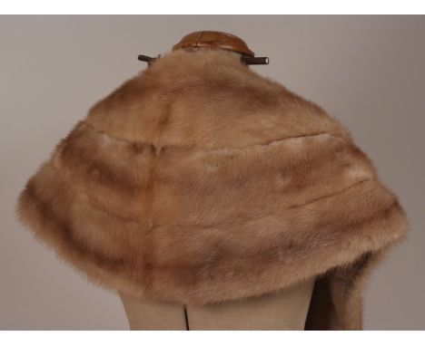 A BLONDE MINK CAPE/STOLE & DARK RABBIT STOLE A very soft and warm light brown mink cape with a collar and mink tail tassels. 